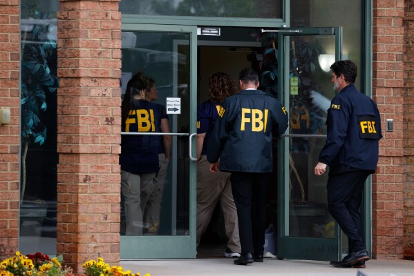FBI personnel enter a building in Portsmouth, Va., Wednesday, May 6, 2026. (Peter Casey/The Virginian-Pilot via AP)