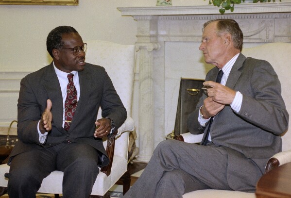 President George H.W. Bush and Supreme Court nominee Clarence Thomas hold a private meeting in the Oval Office at the White House in Washington, Sept. 6, 1991. (AP Photo/Greg Gibson, File)