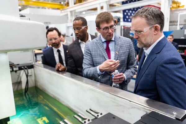 U.S. Trade Representative Jamieson Greer, right, and Rep. John James, R-Mich., second from left, tour the Atomic Industries' manufacturing facility in Warren, Mich. (AP Photo/Julia Demaree Nikhinson)