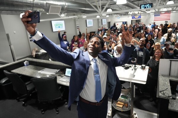 Chedrick Greene, Democratic candidate for 35th Senate District, takes a selfie with supporters after speaking Tuesday, May 5, 2026 in Saginaw, Mich. (AP Photo/Paul Sancya)