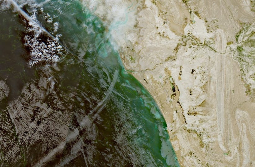 A satellite image shows a fleet of small boats at sea, north of the Strait of Hormuz near the Kargan coast, Iran, April 22, 2026.