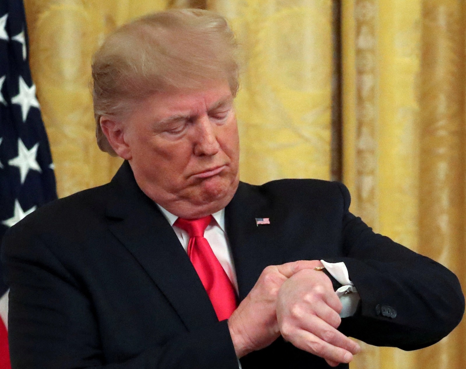 US President Donald Trump checks his watch during an event in the White House in Washington, DC, US, November 6, 2019.