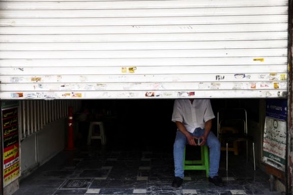 A man sit at his shop in a street, after US President Donald Trump said that he had agreed to a two-week ceasefire with Iran, in Tehran, Iran, April 8, 2026.