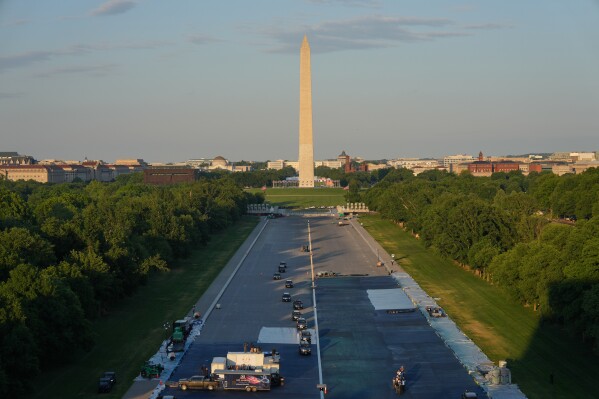 The motorcade with President Donald Trump drives in the Lincoln Memorial Reflecting Pool during a visit to see the new blue protective coating being applied as part of a renovation project, Thursday, May 7, 2026, in Washington. (AP Photo/Alex Brandon, Pool)