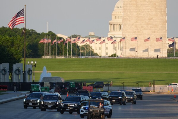 The motorcade with President Donald Trump drives in the Lincoln Memorial Reflecting Pool as he arrives to to see the new blue protective coating being applied as part of a renovation project, Thursday, May 7, 2026, in Washington. (AP Photo/Mark Schiefelbein)
