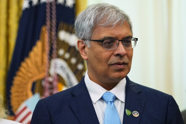 National Institutes of Health Director Dr. Jay Bhattacharya listens to President Donald Trump speak in the Oval Office of the White House, April 18, 2026, in Washington. (AP Photo/Julia Demaree Nikhinson, File)