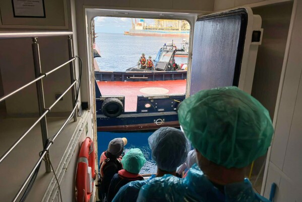 Passengers are being disembarked from the hantavirus-stricken cruise ship MV Hondius at the port of Granadilla in Tenerife, Canary Islands, Spain, Sunday, May 10, 2026. (AP Photo)
