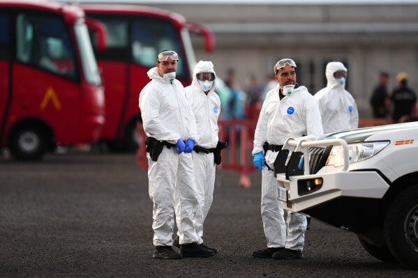Civil Guard border police officers following the arrival of hantavirus-stricken cruise ship MV Hondius at the port of Granadilla in Tenerife, Canary Islands, Spain, Sunday, May 10, 2026. (AP Photo)