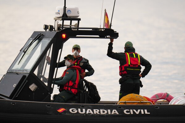 Civil Guard officers patrol next to the hantavirus-stricken cruise ship MV Hondius after its arrival at the port of Granadilla in Tenerife, Canary Islands, Spain, Sunday, May 10, 2026. (AP Photo/Manu Fernandez)