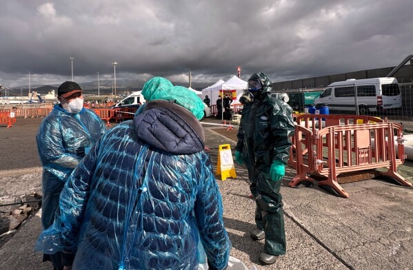 Passengers are disembarked from the hantavirus-stricken cruise ship MV Hondius at the port of Granadilla in Tenerife, Canary Islands, Spain, Sunday, May 10, 2026. (AP Photo)