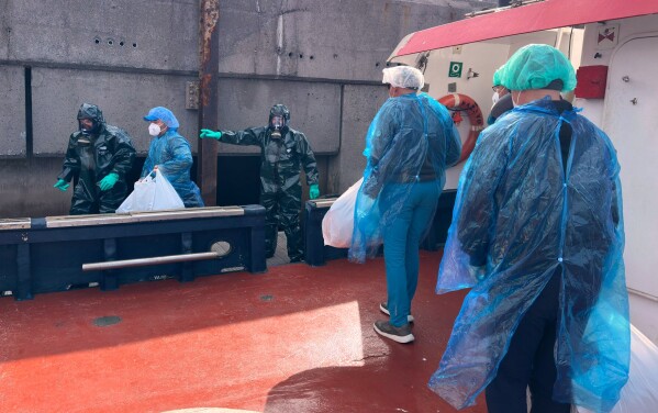 Passengers are disembarked from the hantavirus-stricken cruise ship MV Hondius at the port of Granadilla in Tenerife, Canary Islands, Spain, Sunday, May 10, 2026. (AP Photo)