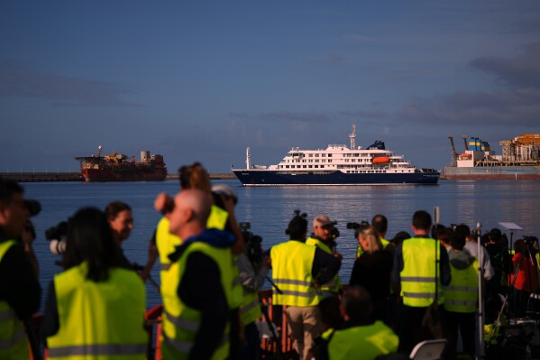 Media and emergency services personnel work next the hantavirus-stricken cruise ship MV Hondius after its arrival at the port of Granadilla in Tenerife, Canary Islands, Spain, Sunday, May 10, 2026. (AP Photo/Manu Fernandez)