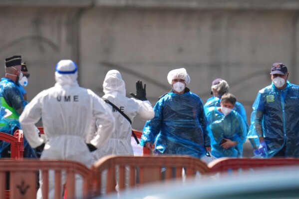 Passengers are disembarked from the hantavirus-stricken cruise ship MV Hondius at the port of Granadilla in Tenerife, Canary Islands, Spain, Sunday, May 10, 2026. (AP Photo/Manu Fernandez)
