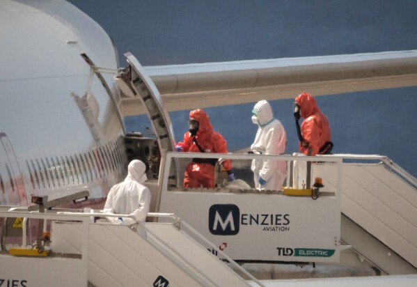 A Spanish passenger boards a government plane after disembarking from the hantavirus-stricken cruise ship MV Hondius at the airport in Tenerife, Canary Islands, Spain, Sunday, May 10, 2026. (AP Photo/Arturo Rodriguez)
