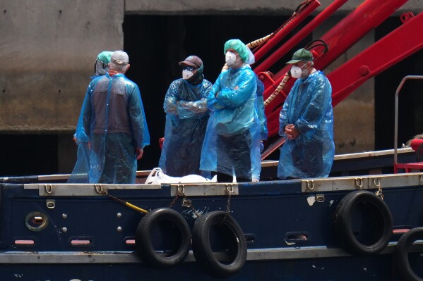 Passengers are disembarked from the hantavirus-stricken cruise ship MV Hondius at the port of Granadilla in Tenerife, Canary Islands, Spain, Sunday, May 10, 2026. (AP Photo/Manu Fernandez)