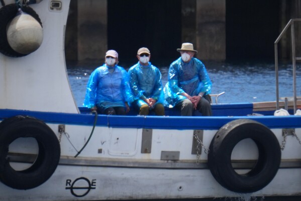 Passengers are disembarked from the hantavirus-stricken cruise ship MV Hondius at the port of Granadilla in Tenerife, Canary Islands, Spain, Sunday, May 10, 2026. (AP Photo/Manu Fernandez)