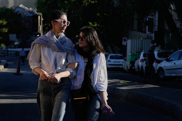 Women walk in northern Tehran, Iran, Sunday, May 10, 2026. (AP Photo/Vahid Salemi)