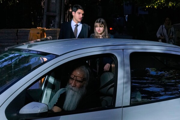 A man drives as the others walk in northern Tehran, Iran, Sunday, May 10, 2026. (AP Photo/Vahid Salemi)