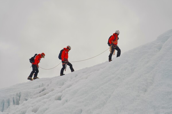Mountaineers participate in a training session at the Khumbu Icefall as they prepare for their ascent to the summit of Mount Everest, Nepal, Sunday, May 3, 2026. (AP Photo/Pasang Rinzee Sherpa)