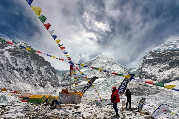 Prayers flags furl over the guides' and mountaineers' tents at the base camp of the Mount Everest, Nepal, Sunday, May 10, 2026. (AP Photo/Pasang Rinzee Sherpa)