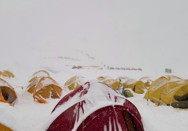 Snow covers tents during a period of inclement weather at the Everest Base Camp, Nepal, Thursday, May 7, 2026. (AP Photo/Pasang Rinzee Sherpa)