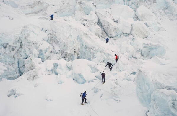 Mountaineers ascend Khumbu Icefall on their way to the summit of Mount Everest in Kathmandu, Nepal, Saturday, May 9, 2026. (AP Photo/Pasang Rinzee Sherpa)