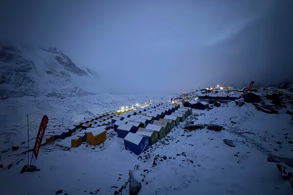 Snow covers tents during a period of inclement weather at the Everest Base Camp, Nepal, Saturday, May 9, 2026. (AP Photo/Pasang Rinzee Sherpa)