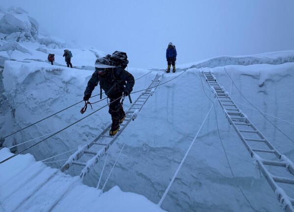 Mountaineers ascend Khumbu Icefall on their way to the summit of Mount Everest, Nepal, Thursday, May 7, 2026. (AP Photo/Pasang Rinzee Sherpa)