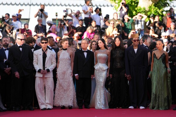 Jury president Park Chan-wook, fourth from left, poses with jury members Stellan Skarsgård, from left, Diego Céspedes, Laura Wandel, Demi Moore, Chloé Zhao, Isaach de Bankolé and Ruth Negga at the opening ceremony and premiere of the film 'The Electric Kiss' during 79th international film festival, Cannes, southern France, Tuesday, May 12, 2026. (AP Photo/Andreea Alexandru)