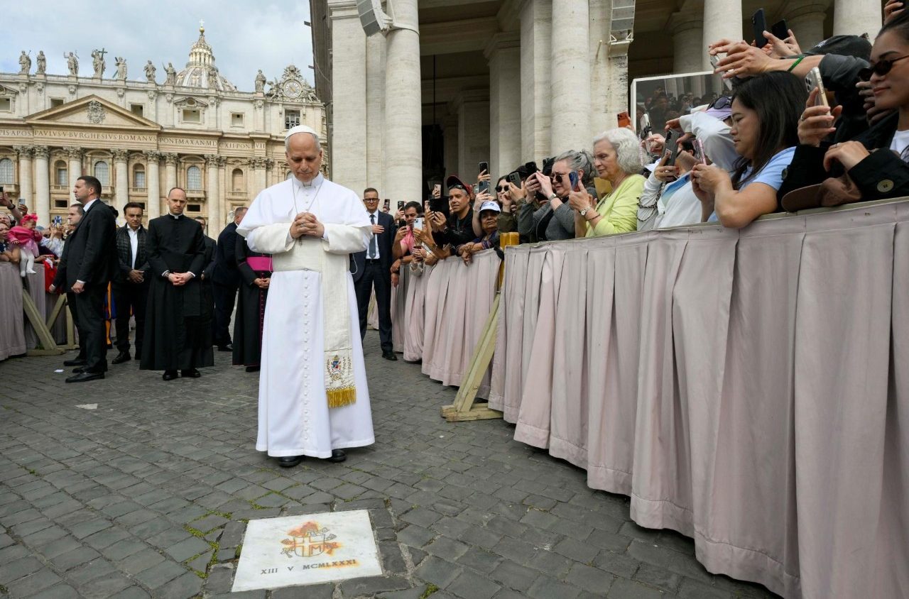 Pope Leo XIV prays at the spot where St. John Paul II was shot