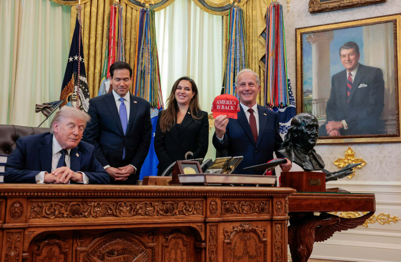 US Ambassador to Lebanon Michel Issa holds an "America is back" hat signed by US President Donald Trump next to Lebanon Ambassador to the US Nada Hamadeh Moawad, Secretary of State Marco Rubio and Trump in the Oval Office at the White House, in Washington DC, April 23, 2026.