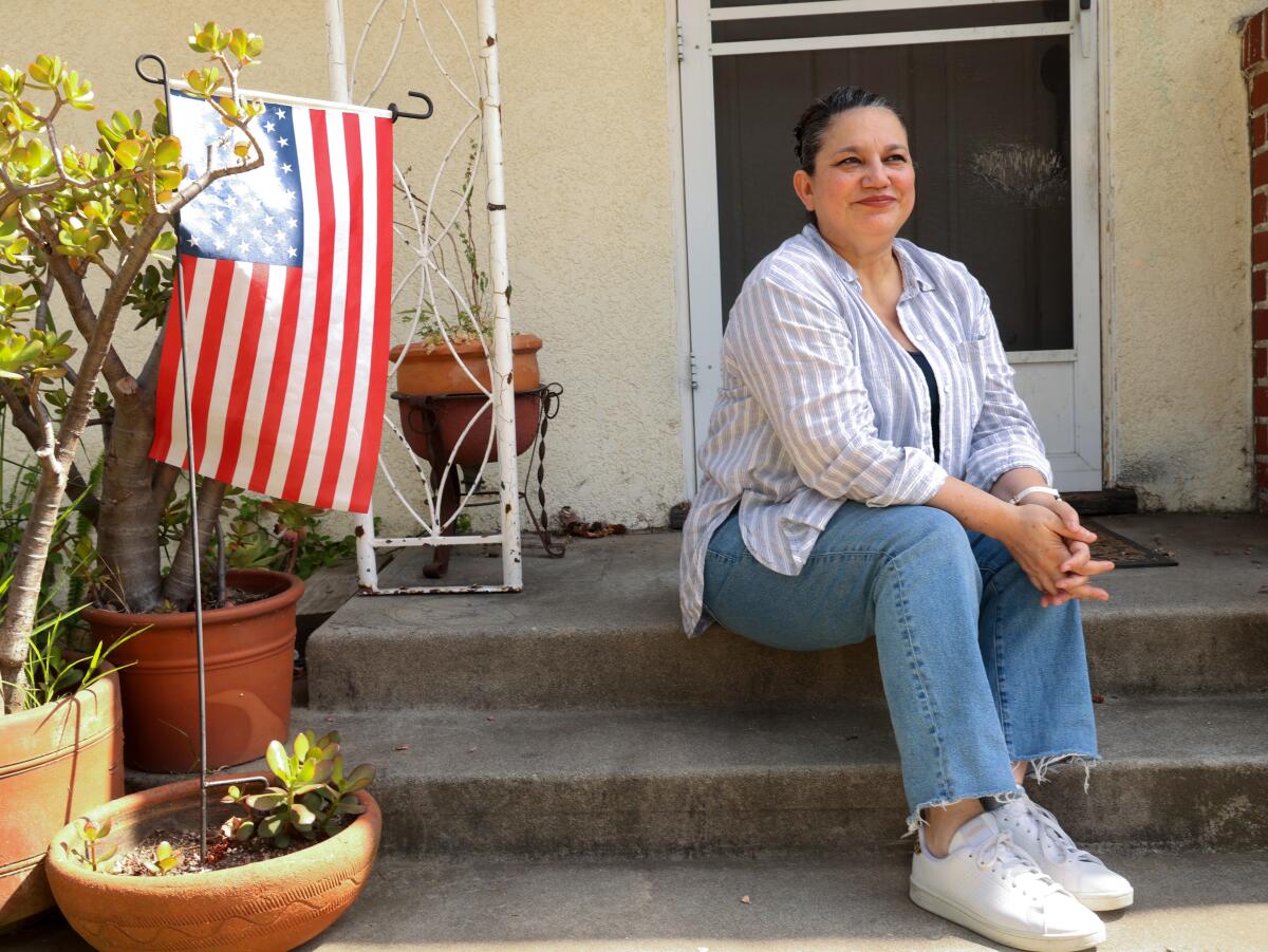 Longtime Arcadia resident Sonia Martin sits on the porch of her home.