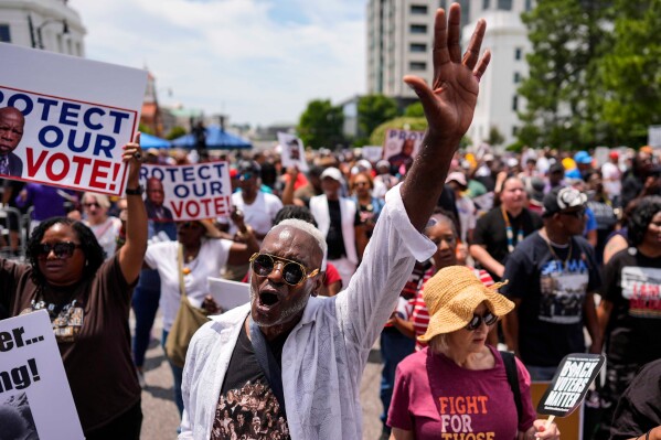 A man sings a spirtual song during a voting rally, Saturday, May 16, 2026, in Montgomery, Ala. (AP Photo/Mike Stewart)