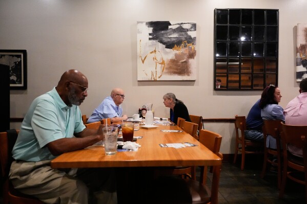 Supporters of U.S. Senate candidate, current Louisiana treasurer and former U.S. Representative (R-La.) John Fleming, wait for him to speak at a Ronald Reagan Newsmaker Luncheon in Baton Rouge, La., Tuesday, May 12, 2026. (AP Photo/Gerald Herbert)