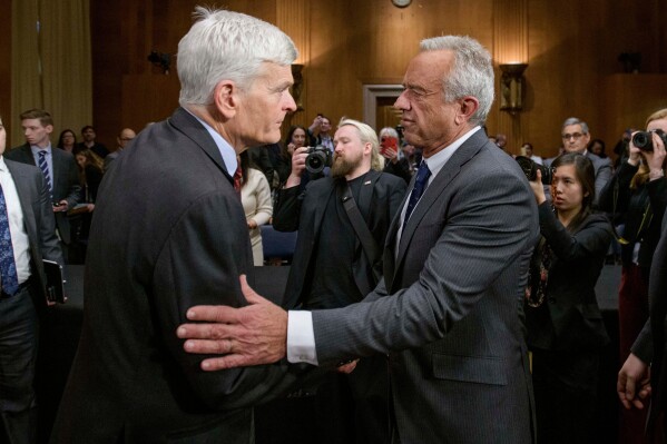 Robert F. Kennedy, Jr., right, President Donald Trump's nominee to serve as Secretary of Health and Human Services, talks with Committee Chairman Sen. Bill Cassidy, R-La., following his confirmation hearing on Capitol Hill, Jan. 30, 2025, in Washington. (AP Photo/Rod Lamkey, Jr., File)