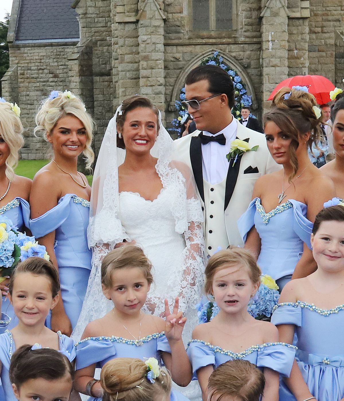 The wedding of Venezuela Fury and Noah Price, with the bridesmaids in blue dresses made by Evangeline Designs