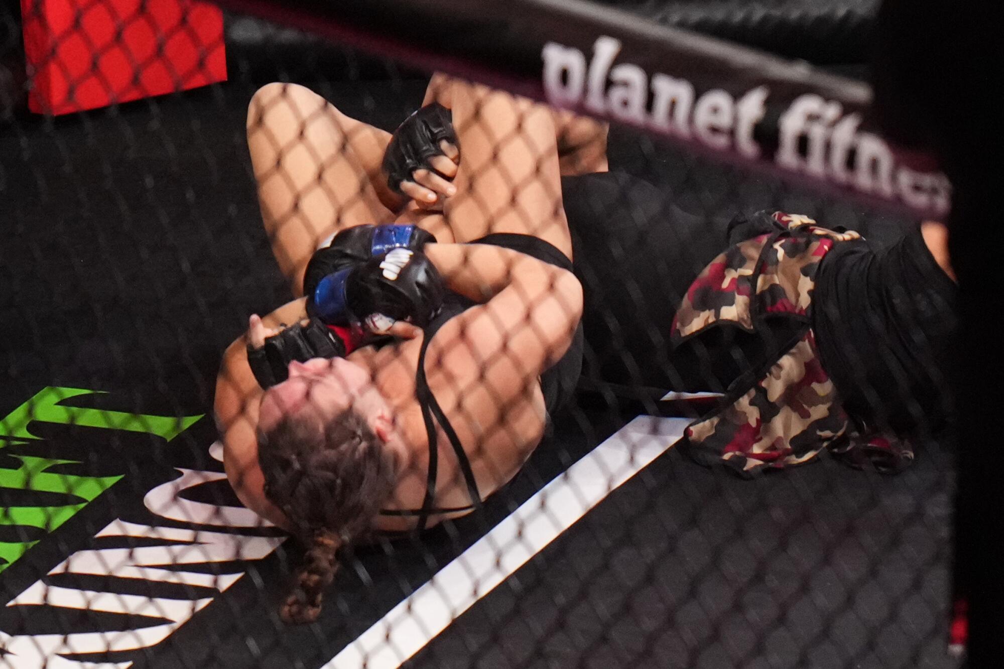 Ronda Rousey uses an armbar to defeat Gina Carano in 17 seconds on Saturday at Intuit Dome.