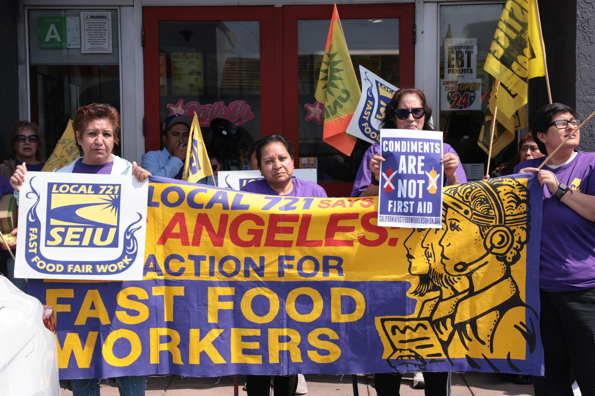 Members of SEIU Local 721 protest in support of fast-food workers outside a Carl's Jr.