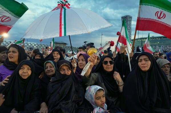 A group of women attend a mass wedding ceremony for couples participating in the "Janfada" ("Sacrifice for Iran") pro-government campaign in Tehran, Iran, Monday, May 18, 2026. (AP Photo/Vahid Salemi)