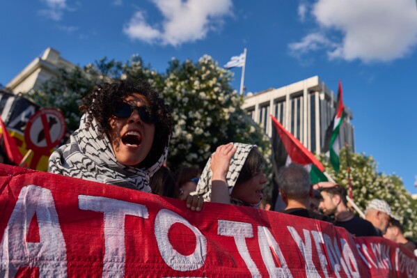 Protesters chant pro-Palestinian slogans outside Greece's Foreign Ministry after Israel's navy intercepted an activists flotilla in waters off of Cyprus, in Athens on Monday, May 18, 2026. (AP Photo/Petros Giannakouris)