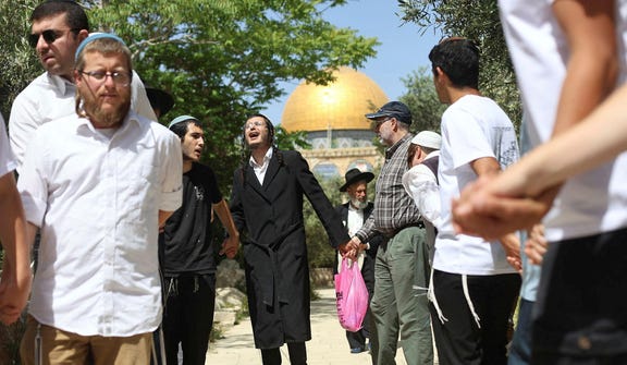 Israeli Jews celebrate the anniversary of East Jerusalem's capture by the IDF in 1967, at the Temple Mount/Al-Aqsa compound, on Thursday.