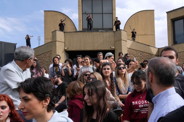 Musicians, rear, play kudu horns during a performance dubbed "Sounds of the South," featuring music from southern Iran, as people attend the event at the Tehran Museum of Contemporary Art in Tehran, Iran, Thursday, May 21, 2026. (AP Photo/Vahid Salemi)