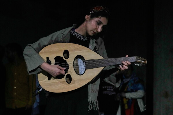 Musician Atena Kharyaband plays the oud during a performance dubbed "Sounds of the South," featuring music from southern Iran, at the Tehran Museum of Contemporary Art in Tehran, Iran, Thursday, May 21, 2026. (AP Photo/Vahid Salemi)