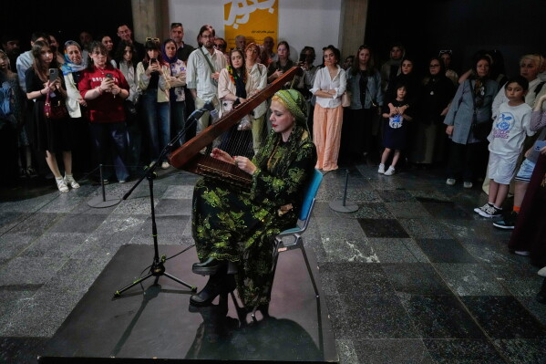 Musician Saleheh Zohrehvand plays the harp during a performance dubbed "Sounds of the South," featuring music from southern Iran, at the Tehran Museum of Contemporary Art in Tehran, Iran, Thursday, May 21, 2026. (AP Photo/Vahid Salemi)