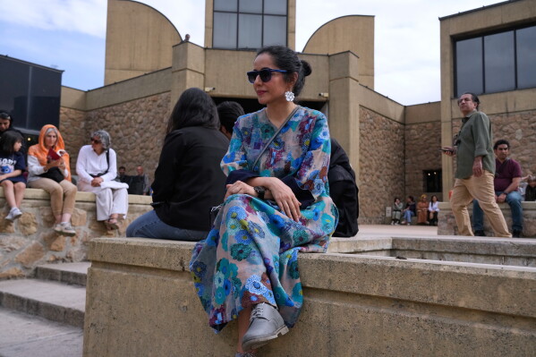 A woman and other attendees wait at the Tehran Museum of Contemporary Art for a music performance dubbed "Sounds of the South," featuring music from southern Iran, in Tehran, Iran, Thursday, May 21, 2026. (AP Photo/Vahid Salemi)