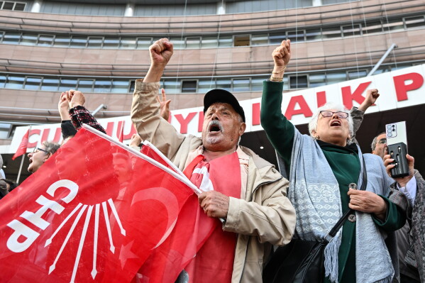 Supporters of Turkey's main opposition Republican People's Party, or CHP, shout slogans as they gather outside the party's headquarters in Ankara, Friday, May 22, 2026. (Gunsu Ozmen/DIA Photo via AP)