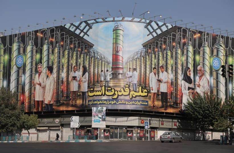 A billboard with Iranian centrifuges illustrations and portraits of nuclear scientists killed in Israeli strikes is displayed on a street in Tehran, Iran August 29, 2025