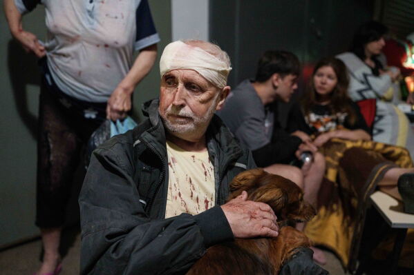 An injured man with his dog takes cover in a shelter after a Russian strike on residential neighbourhood in Kyiv, Ukraine, on Sunday, May 24, 2026. (AP Photo/Evgeniy Maloletka)