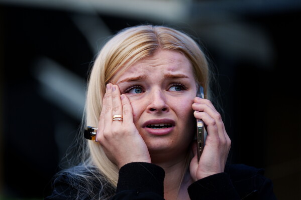 A woman reacts looking at her house destroyed after a Russian strike on Kyiv, Ukraine, on Sunday, May 24, 2026. (AP Photo/Evgeniy Maloletka)