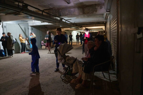 People take cover in a shelter after a Russian strike on a residential neighborhood on Kyiv, Ukraine, on Sunday, May 24, 2026. (AP Photo/Evgeniy Maloletka)